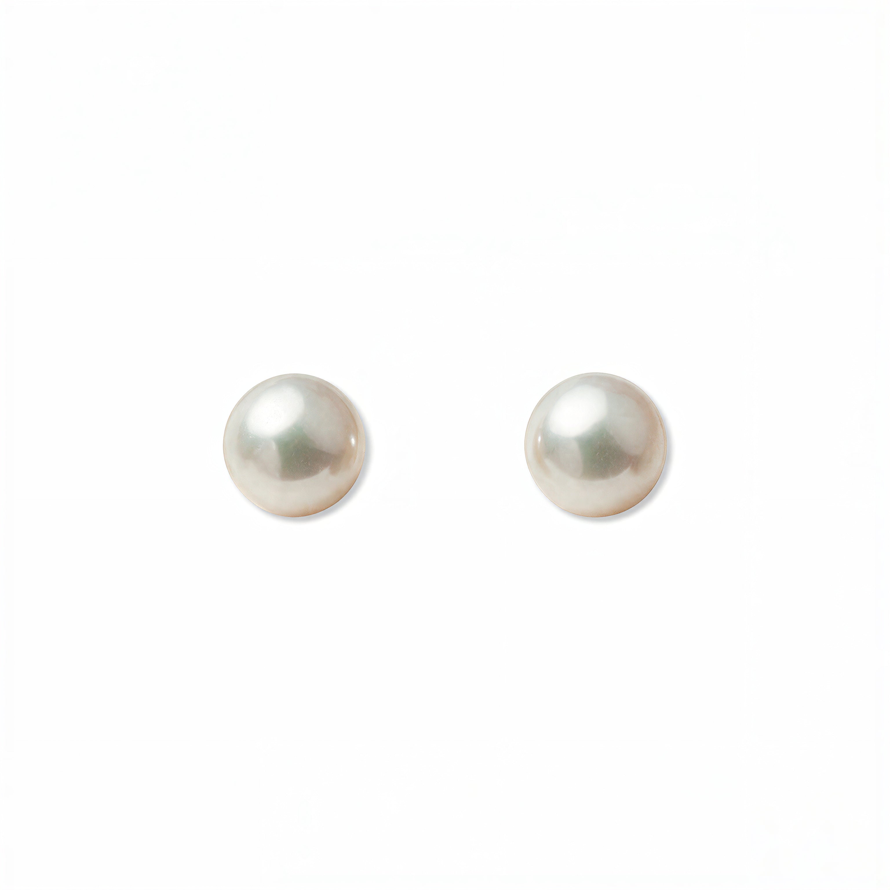 A pair of Freshwater Cultured Pearl 6mm Stud Earrings by Skōsh Jewelry, featuring round, lustrous white freshwater pearls on sterling silver post backs, displayed against a white background.