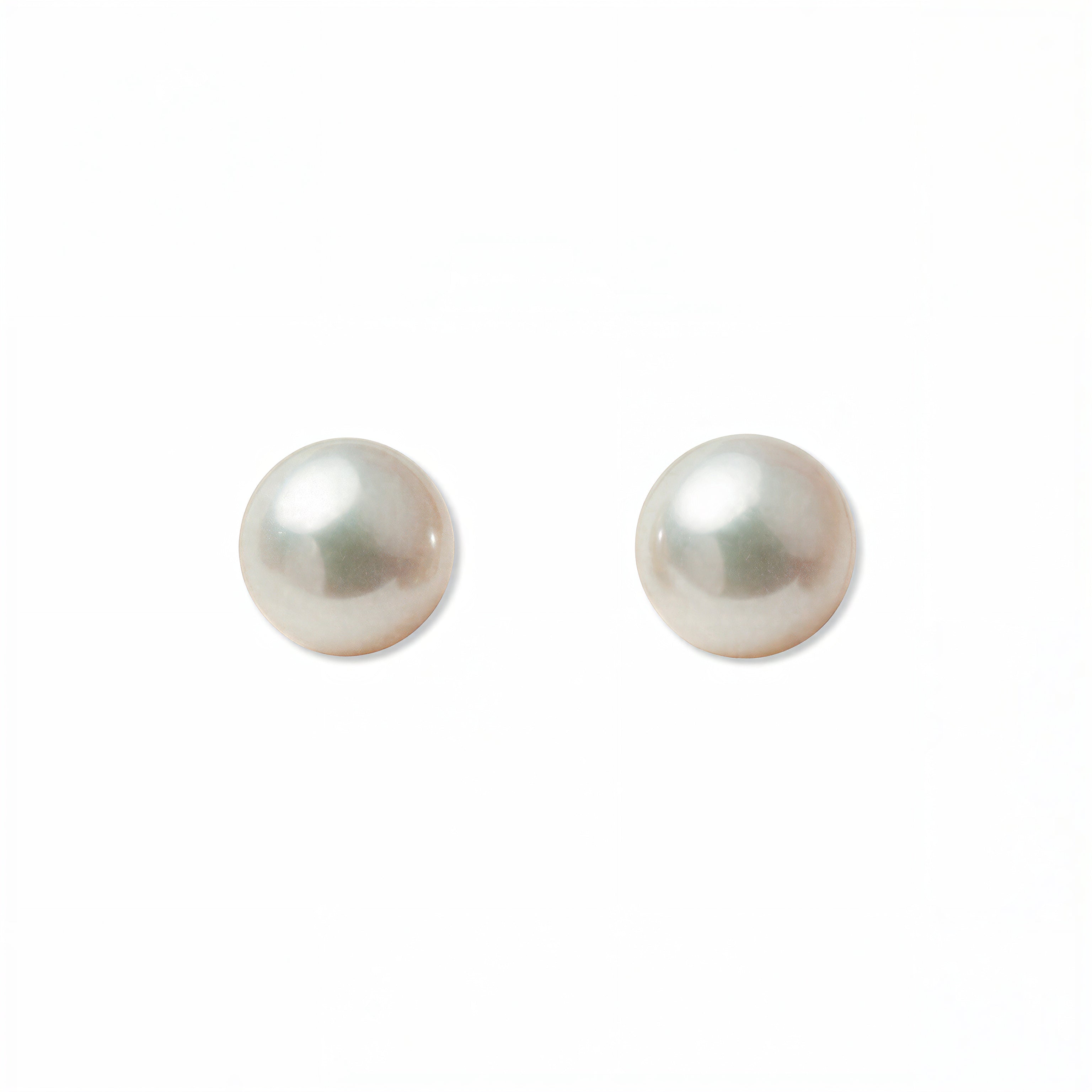 A pair of Freshwater Cultured Pearl 8mm Stud Earrings by Skōsh Jewelry, featuring round, lustrous white freshwater pearls on sterling silver post backs, displayed against a white background.
