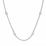A Nine Station Freshwater Pearl Necklace by Skōsh Jewelry, featuring small white freshwater pearls spaced evenly along a fine sterling silver station chain, displayed against a white background.