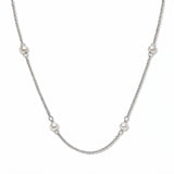 A Nine Station Freshwater Pearl Necklace by Skōsh Jewelry, featuring small white freshwater pearls spaced evenly along a fine sterling silver station chain, displayed against a white background.