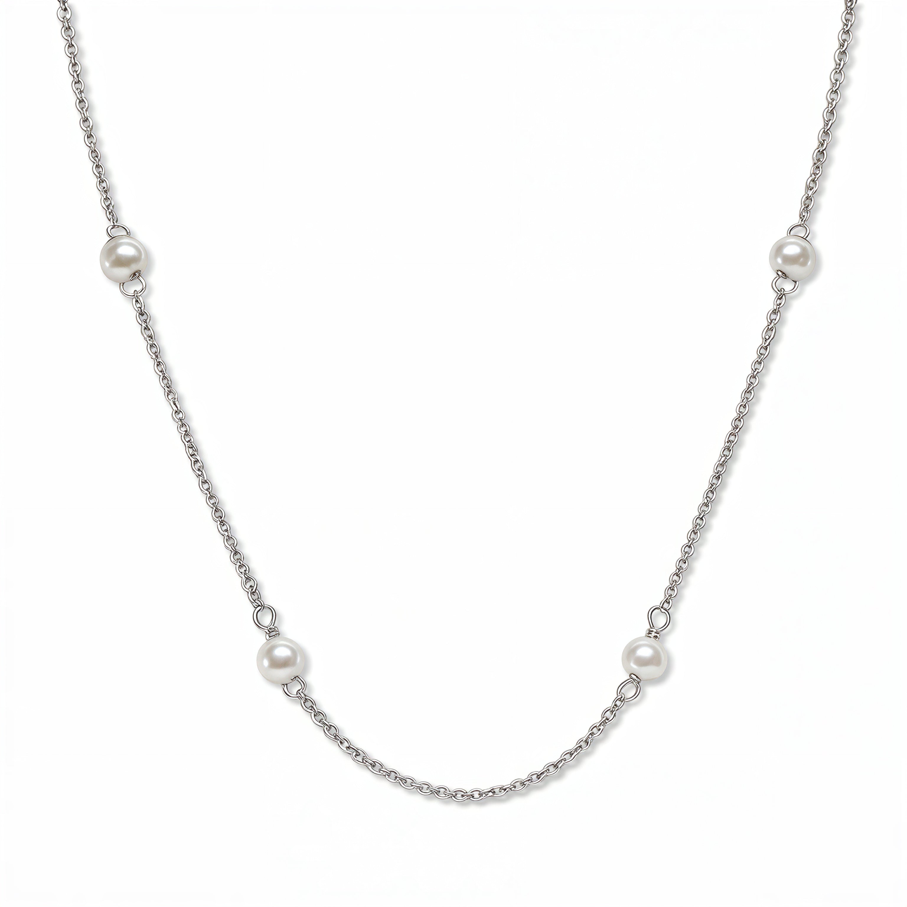 A Nine Station Freshwater Pearl Necklace by Skōsh Jewelry, featuring small white freshwater pearls spaced evenly along a fine sterling silver station chain, displayed against a white background.