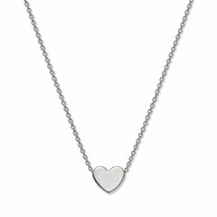 A Love Polished Heart Necklace by Skōsh Jewelry, featuring a small flat, polished heart set on a fine sterling silver chain, displayed against a white background.
