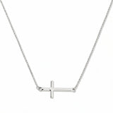 An Abide Sideways Cross Necklace by Skōsh Jewelry, featuring a classic polished cross set sideways on a fine sterling silver chain, displayed against a white background.