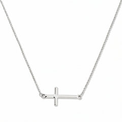 An Abide Sideways Cross Necklace by Skōsh Jewelry, featuring a classic polished cross set sideways on a fine sterling silver chain, displayed against a white background.