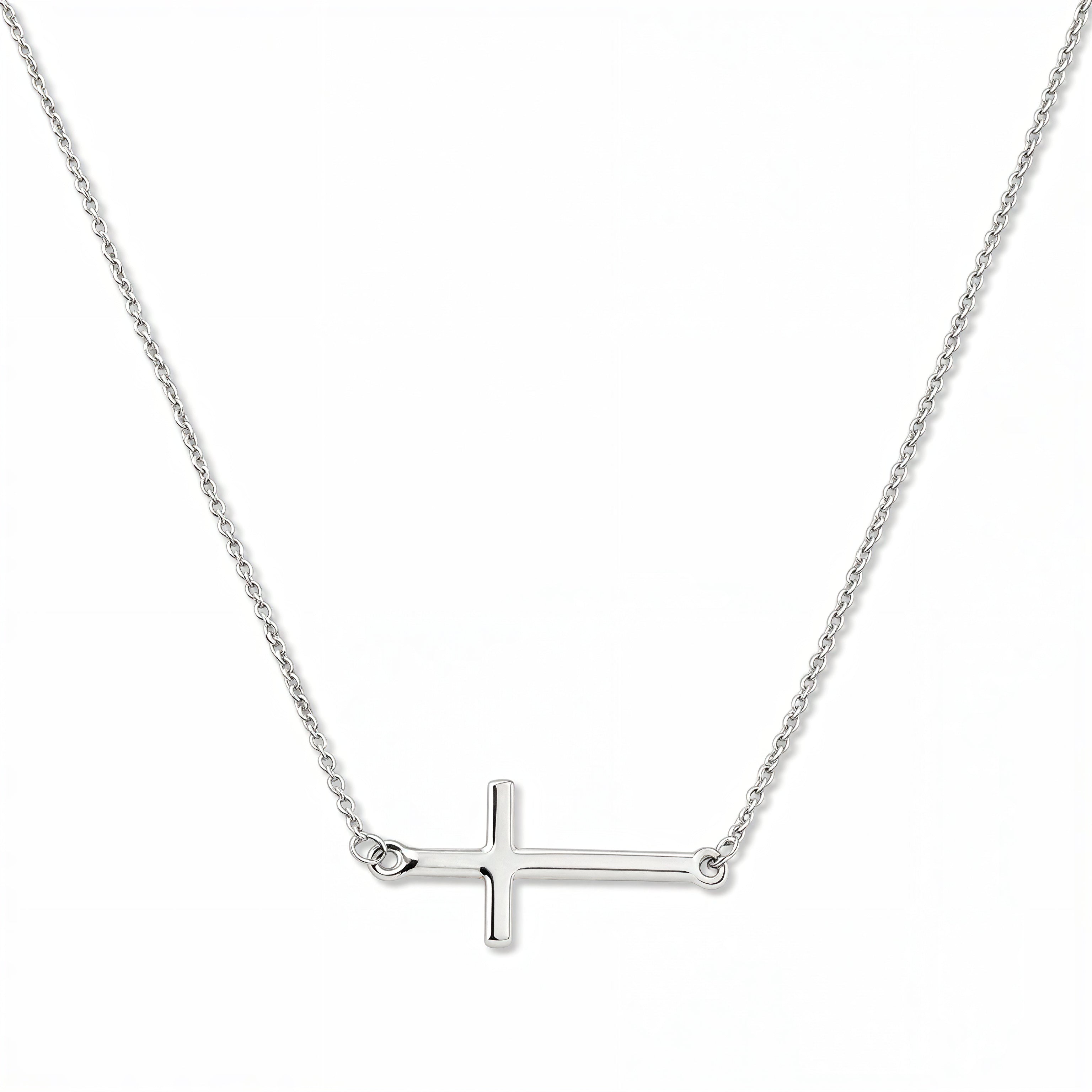 An Abide Sideways Cross Necklace by Skōsh Jewelry, featuring a classic polished cross set sideways on a fine sterling silver chain, displayed against a white background.