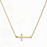 An Abide Sideways Cross Necklace by Skōsh Jewelry, featuring a classic polished cross set sideways on a fine gold chain, displayed against a white background.