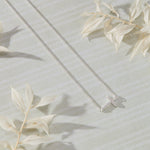 Devoted White Cubic Zirconia Sideways Cross Necklace in sterling silver by Skōsh Jewelry
