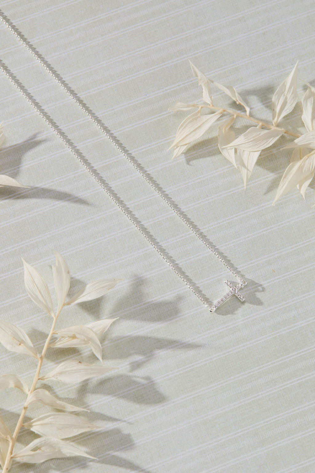 Devoted White Cubic Zirconia Sideways Cross Necklace in sterling silver by Skōsh Jewelry