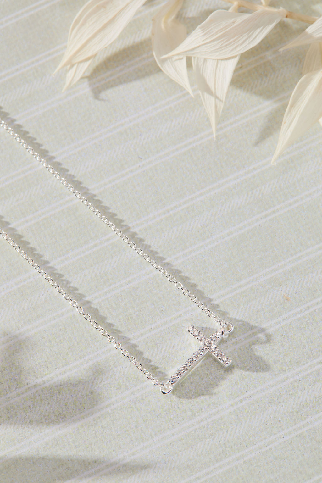 Devoted White Cubic Zirconia Sideways Cross Necklace in sterling silver by Skōsh Jewelry