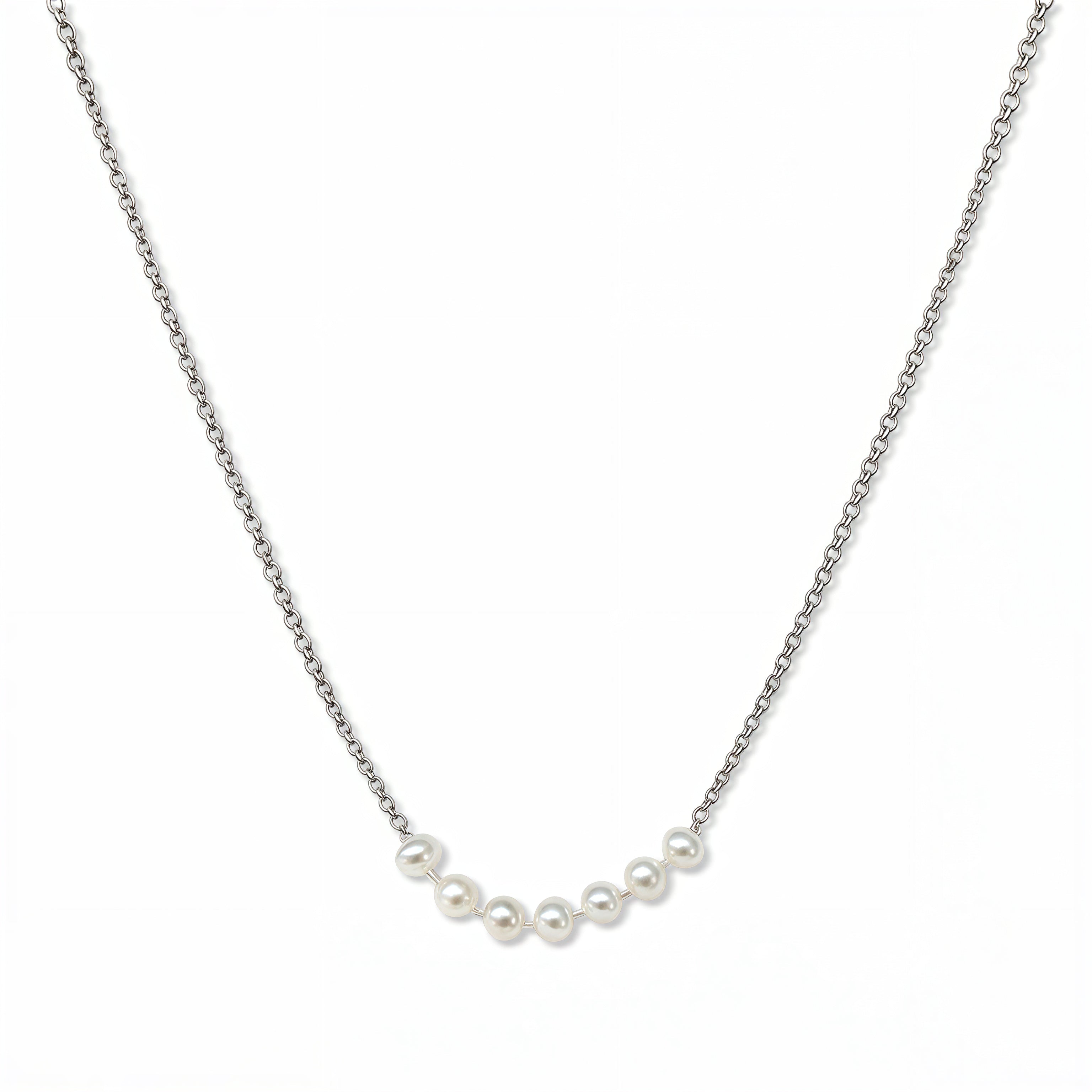 A Daily Prayer Seven Freshwater Pearl Necklace by Skōsh Jewelry, featuring a row of seven small white freshwater pearls along a fine sterling silver chain, displayed against a white background.