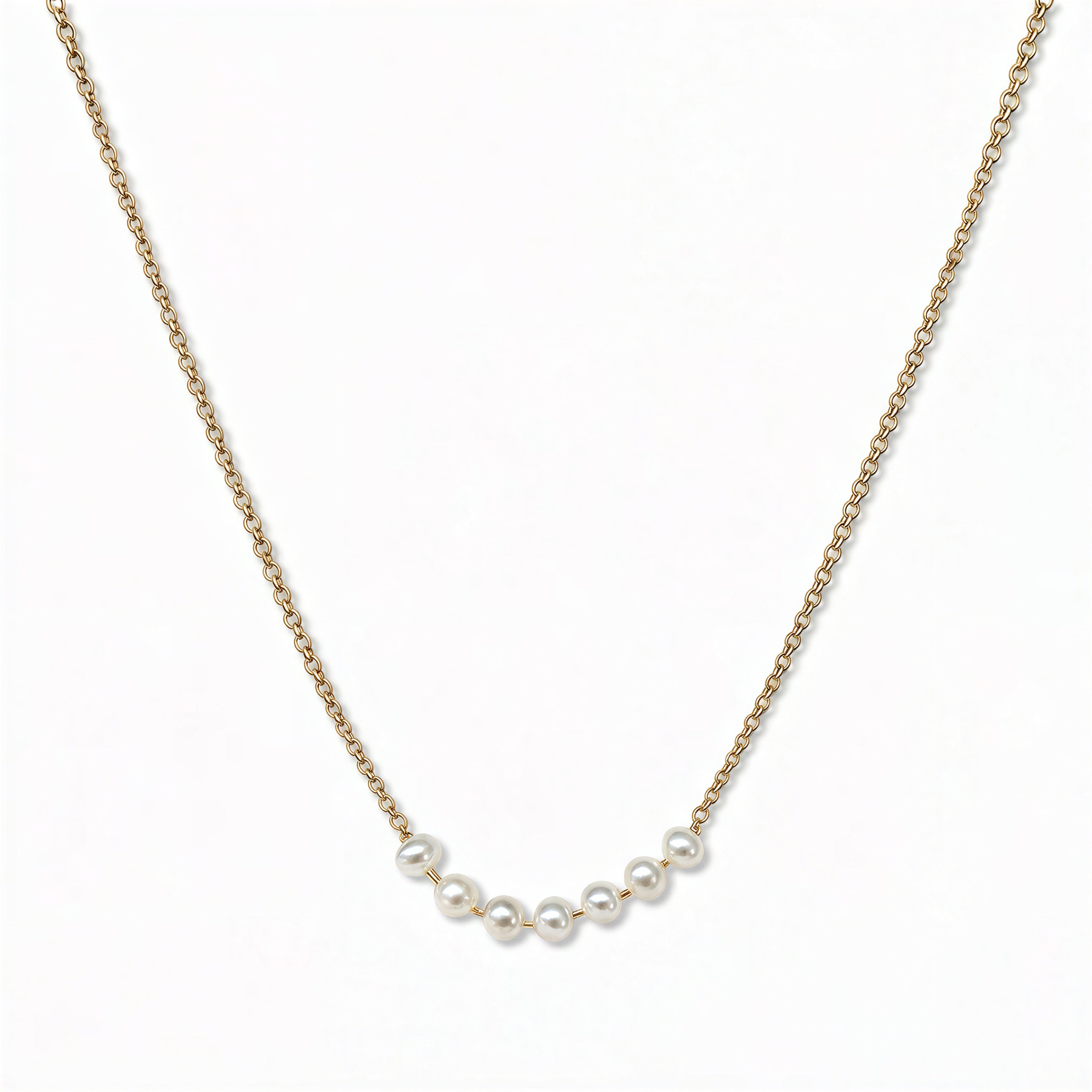 A Daily Prayer Seven Freshwater Pearl Necklace by Skōsh Jewelry, featuring a row of seven small white freshwater pearls along a fine gold chain, displayed against a white background.