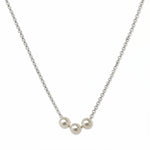A Timeless Trio Freshwater Pearl Necklace by Skōsh Jewelry, featuring three white freshwater pearls in a row along a fine sterling silver chain, displayed against a white background.