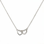 A Forever Love Interlocking Hearts Necklace by Skōsh Jewelry, featuring two open hearts linked together on a fine sterling silver chain, displayed against a white background.