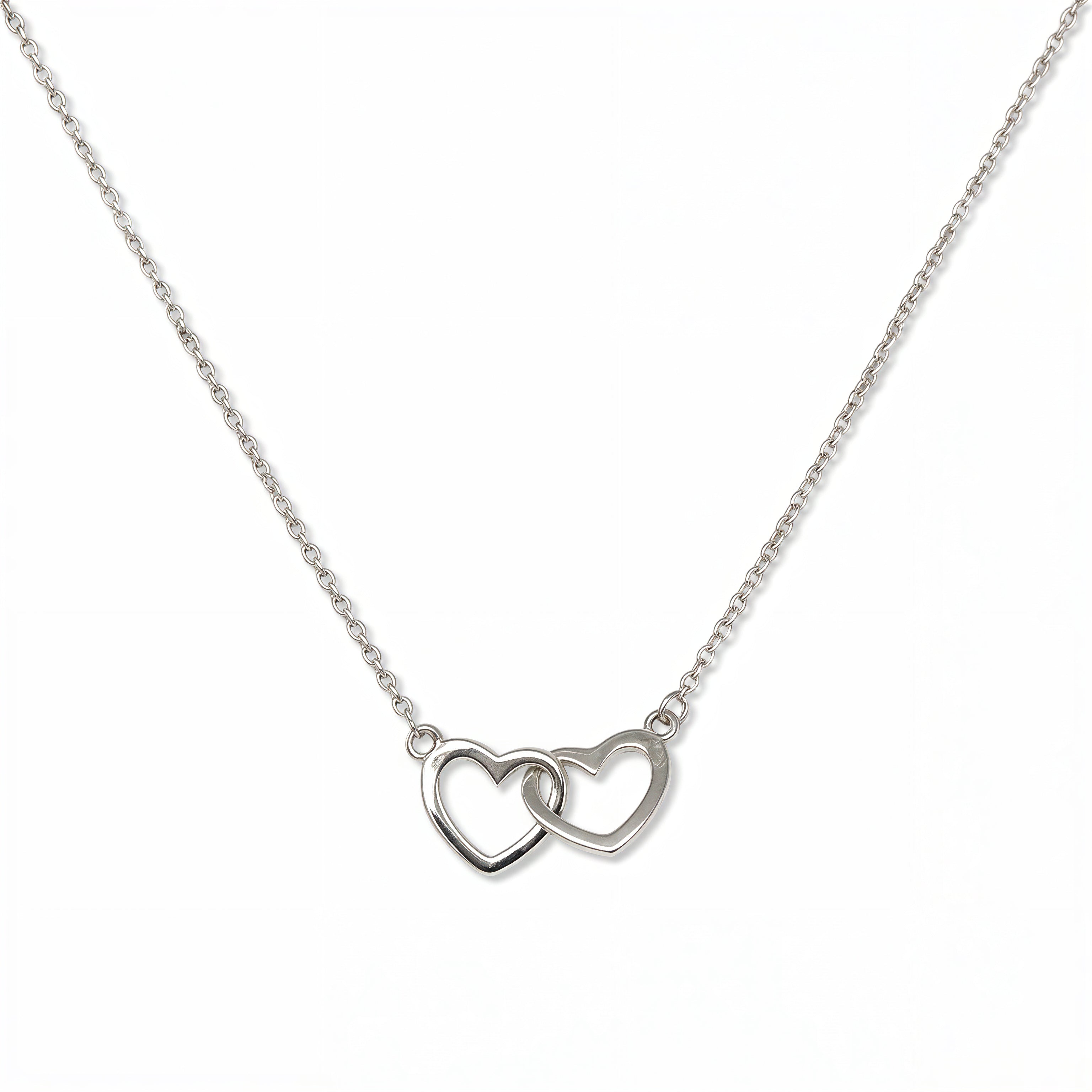 A Forever Love Interlocking Hearts Necklace by Skōsh Jewelry, featuring two open hearts linked together on a fine sterling silver chain, displayed against a white background.