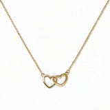 A Forever Love Interlocking Hearts Necklace by Skōsh Jewelry, featuring two open hearts linked together on a fine gold chain, displayed against a white background.