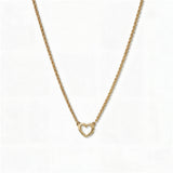 A Lucent Mini Heart Necklace by Skōsh Jewelry, featuring a tiny open heart set on a fine gold chain, displayed against a white background.