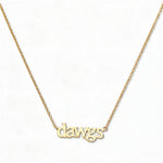 A Dawgs Gameday Necklace by Skōsh Jewelry, featuring the word 'dawgs' in lowercase letters set horizontally on a fine gold chain, displayed against a white background.