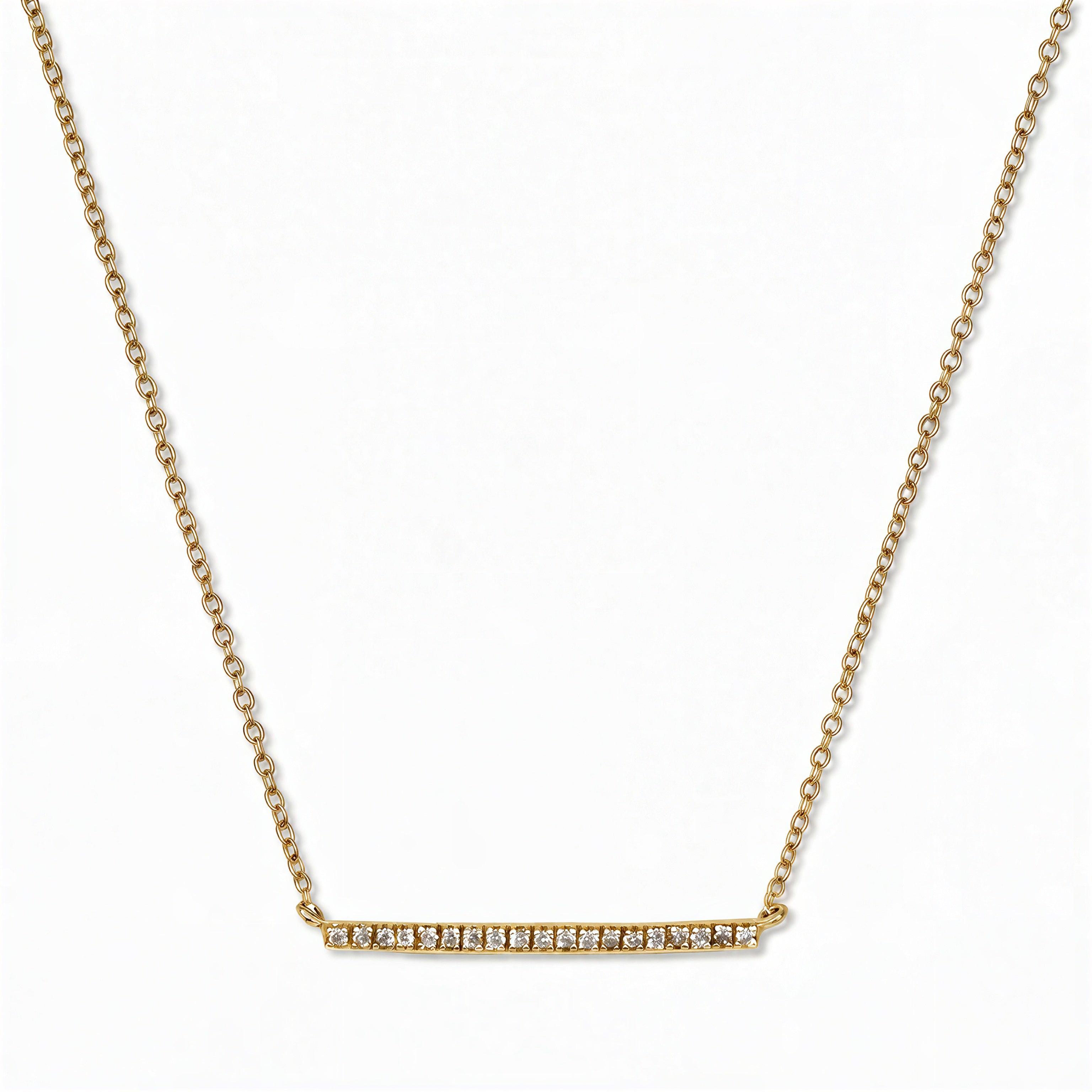 A Luminary White Cubic Zirconia Bar Necklace by Skōsh Jewelry, featuring a long slim bar lined with small clear stones on a fine gold chain, displayed against a white background.
