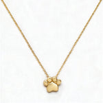 A Bulldogs Paw Print Gameday Necklace by Skōsh Jewelry, featuring a polished paw print pendant on a fine gold chain, displayed against a white background.