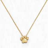 A Bulldogs Paw Print Gameday Necklace by Skōsh Jewelry, featuring a polished paw print pendant on a fine gold chain, displayed against a white background.