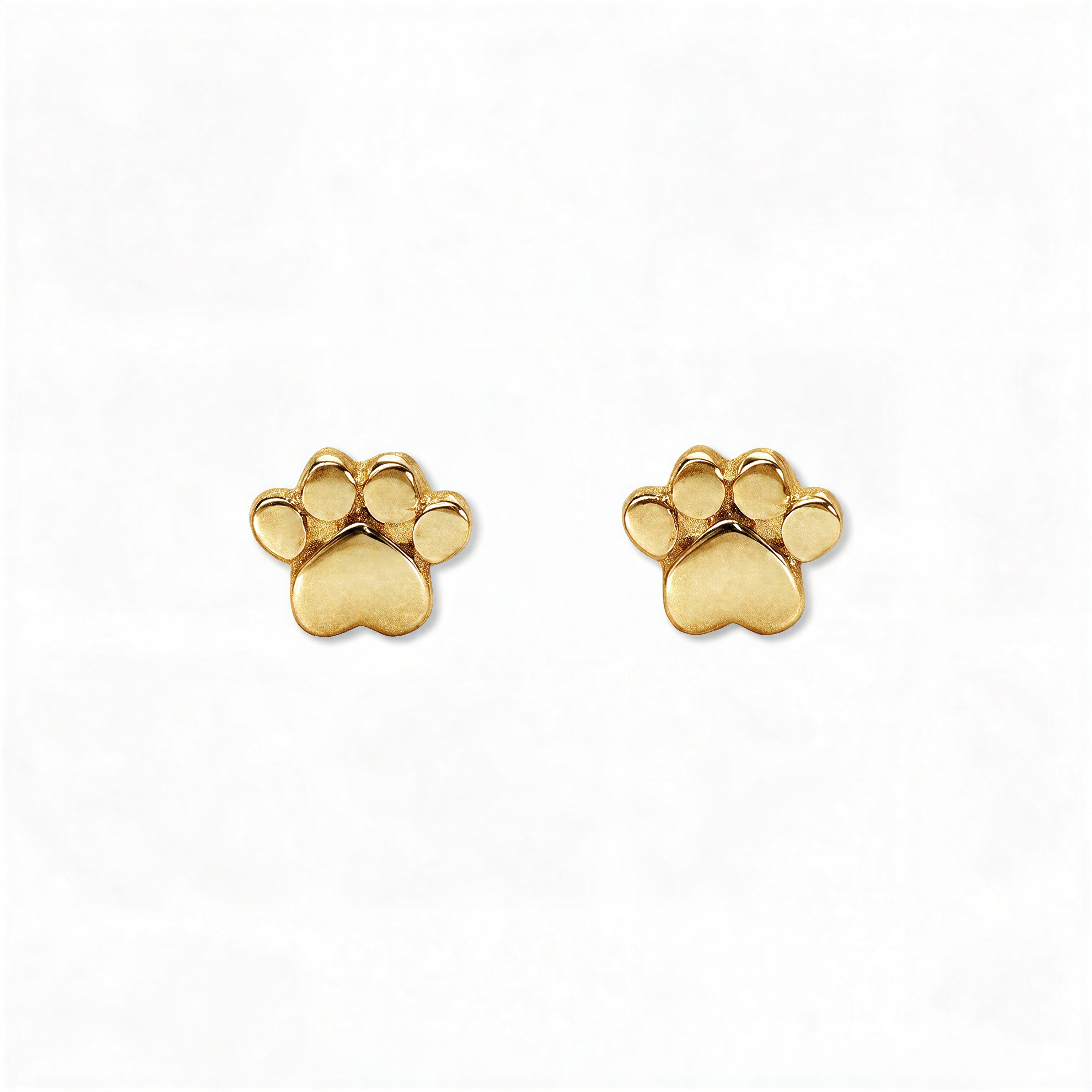A pair of Bulldogs Paw Print Earrings by Skōsh Jewelry, featuring small polished paw print studs in gold, displayed against a white background.