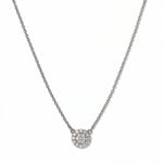 A Luna Glow Pavé Disc White Cubic Zirconia Necklace by Skōsh Jewelry, featuring a round disc covered in small clear pavé stones on a fine sterling silver chain, displayed against a white background.