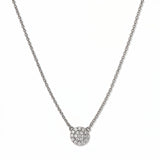 A Luna Glow Pavé Disc White Cubic Zirconia Necklace by Skōsh Jewelry, featuring a round disc covered in small clear pavé stones on a fine sterling silver chain, displayed against a white background.