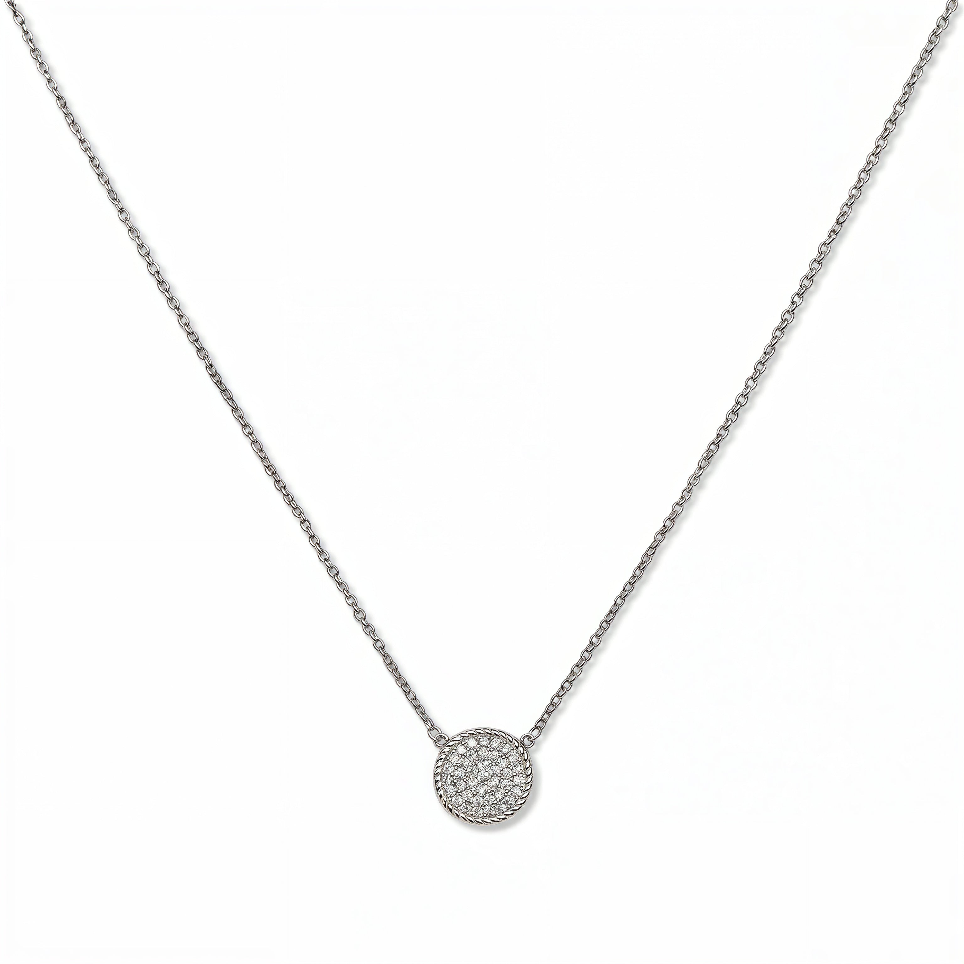 A Purelight Pavé Disc White Cubic Zirconia with Braided Halo Necklace by Skōsh Jewelry, featuring a round pavé disc of clear stones framed by a braided sterling silver halo on a fine chain, displayed against a white background.