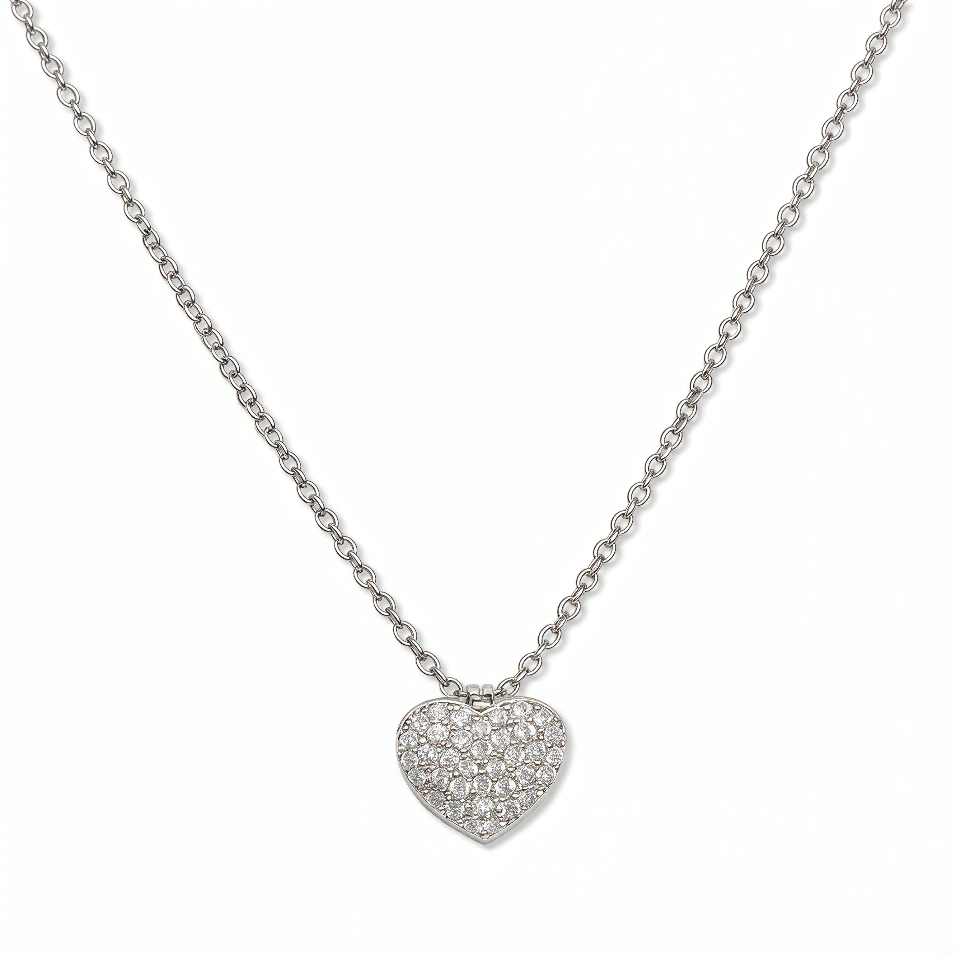 An Affection Pavé Heart White Cubic Zirconia Necklace by Skōsh Jewelry, featuring a puffed heart covered in small clear pavé stones on a fine sterling silver chain, displayed against a white background.