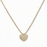 An Affection Pavé Heart White Cubic Zirconia Necklace by Skōsh Jewelry, featuring a puffed heart covered in small clear pavé stones on a fine gold chain, displayed against a white background.