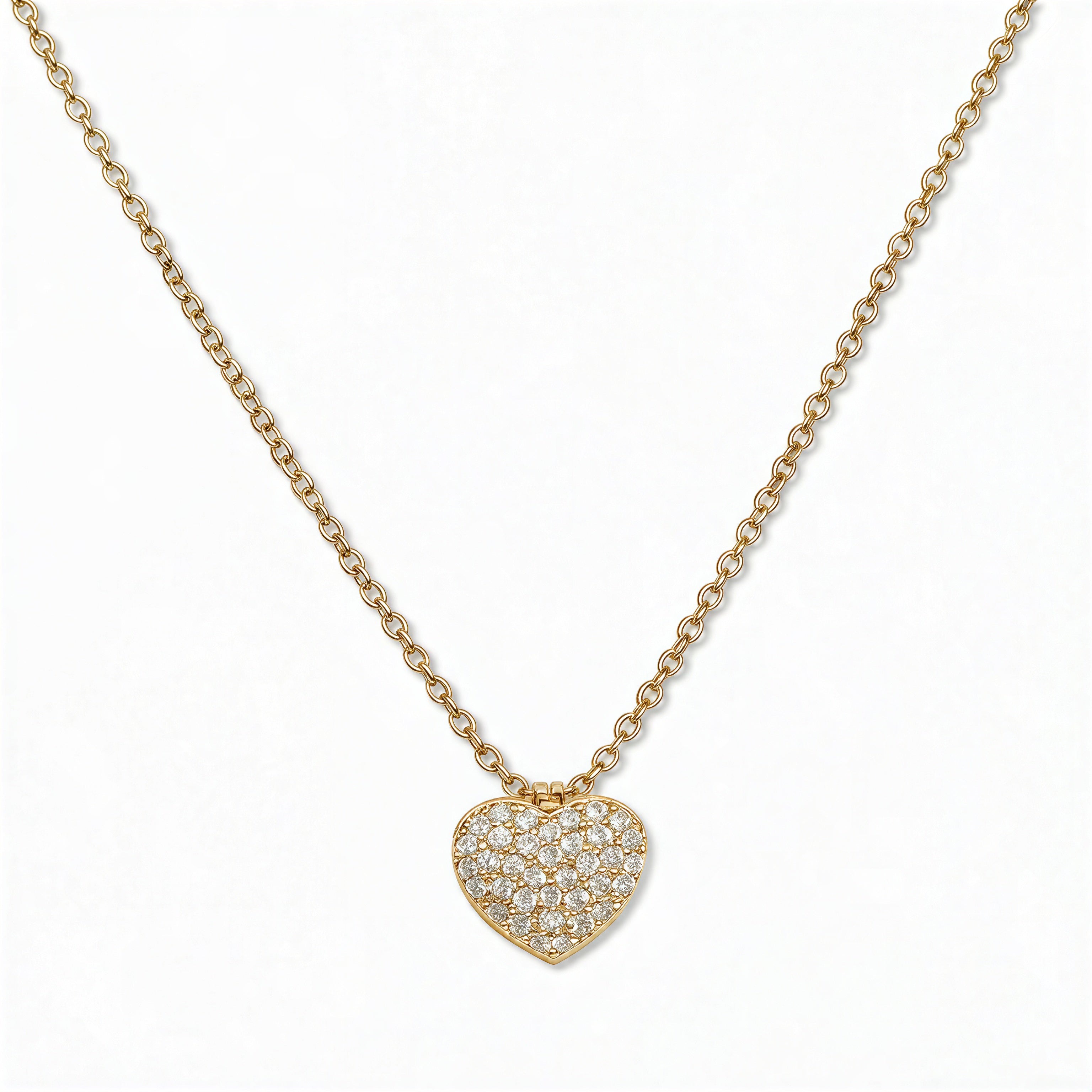 An Affection Pavé Heart White Cubic Zirconia Necklace by Skōsh Jewelry, featuring a puffed heart covered in small clear pavé stones on a fine gold chain, displayed against a white background.