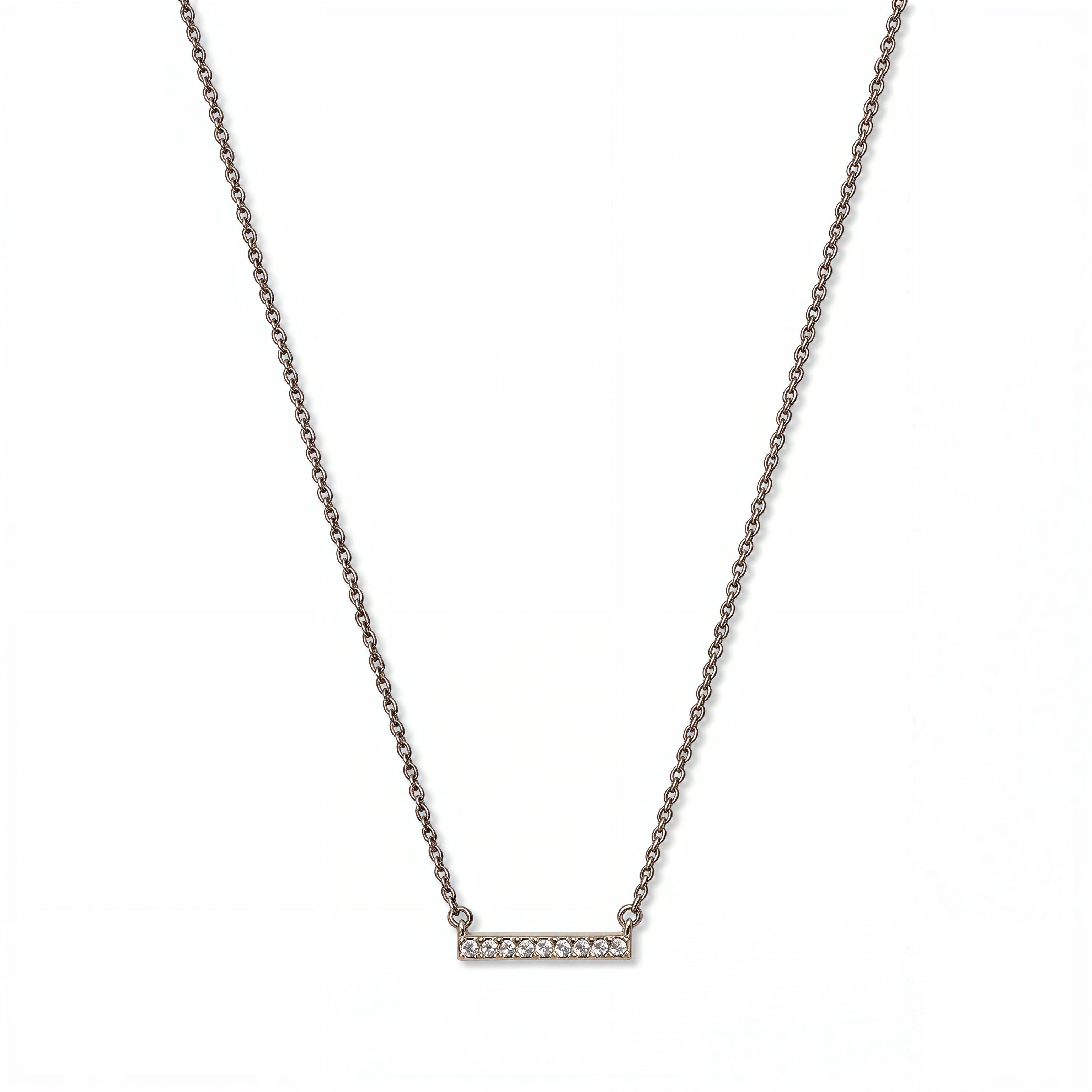 A Luminous White Cubic Zirconia Short Bar Necklace by Skōsh Jewelry, featuring a short slim bar lined with small clear stones on a fine sterling silver chain, displayed against a white background.