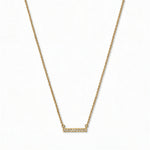 A Luminous White Cubic Zirconia Short Bar Necklace by Skōsh Jewelry, featuring a short slim bar lined with small clear stones on a fine gold chain, displayed against a white background.