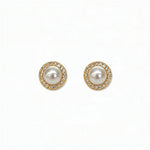 A pair of Freshwater Pearl with White Cubic Zirconia Halo Earrings by Skōsh Jewelry, featuring round white freshwater pearls framed by halos of small clear stones in gold, displayed against a white background.