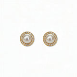 A pair of Freshwater Pearl with White Cubic Zirconia Halo Earrings by Skōsh Jewelry, featuring round white freshwater pearls framed by halos of small clear stones in gold, displayed against a white background.