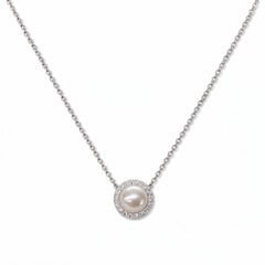 A Freshwater Pearl with White Cubic Zirconia Halo Necklace by Skōsh Jewelry, featuring a round white freshwater pearl surrounded by a halo of small clear stones on a fine sterling silver chain, displayed against a white background.