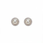 A pair of Freshwater Pearl with White Cubic Zirconia Halo Earrings by Skōsh Jewelry, featuring round white freshwater pearls framed by halos of small clear stones in sterling silver, displayed against a white background.