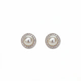 A pair of Freshwater Pearl with White Cubic Zirconia Halo Earrings by Skōsh Jewelry, featuring round white freshwater pearls framed by halos of small clear stones in sterling silver, displayed against a white background.