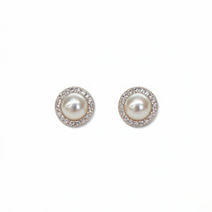 A pair of Freshwater Pearl with White Cubic Zirconia Halo Earrings by Skōsh Jewelry, featuring round white freshwater pearls framed by halos of small clear stones in sterling silver, displayed against a white background.