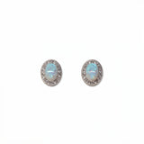 A pair of Ethereal Opal with White Cubic Zirconia Halo Earrings by Skōsh Jewelry, featuring oval iridescent opals framed by halos of small clear stones in sterling silver, displayed against a white background.