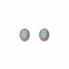 A pair of Ethereal Opal with White Cubic Zirconia Halo Earrings by Skōsh Jewelry, featuring oval iridescent opals framed by halos of small clear stones in sterling silver, displayed against a white background.