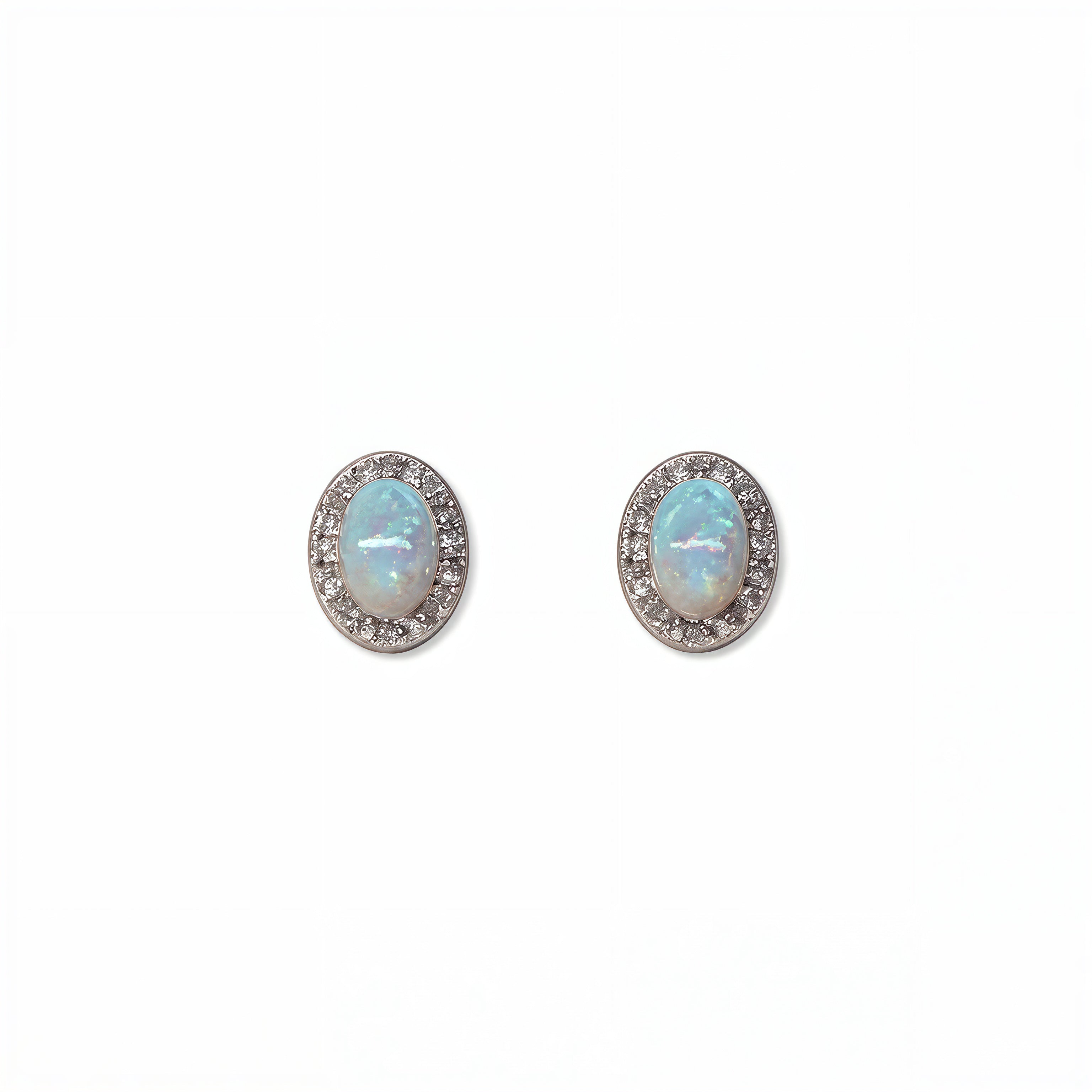 A pair of Ethereal Opal with White Cubic Zirconia Halo Earrings by Skōsh Jewelry, featuring oval iridescent opals framed by halos of small clear stones in sterling silver, displayed against a white background.