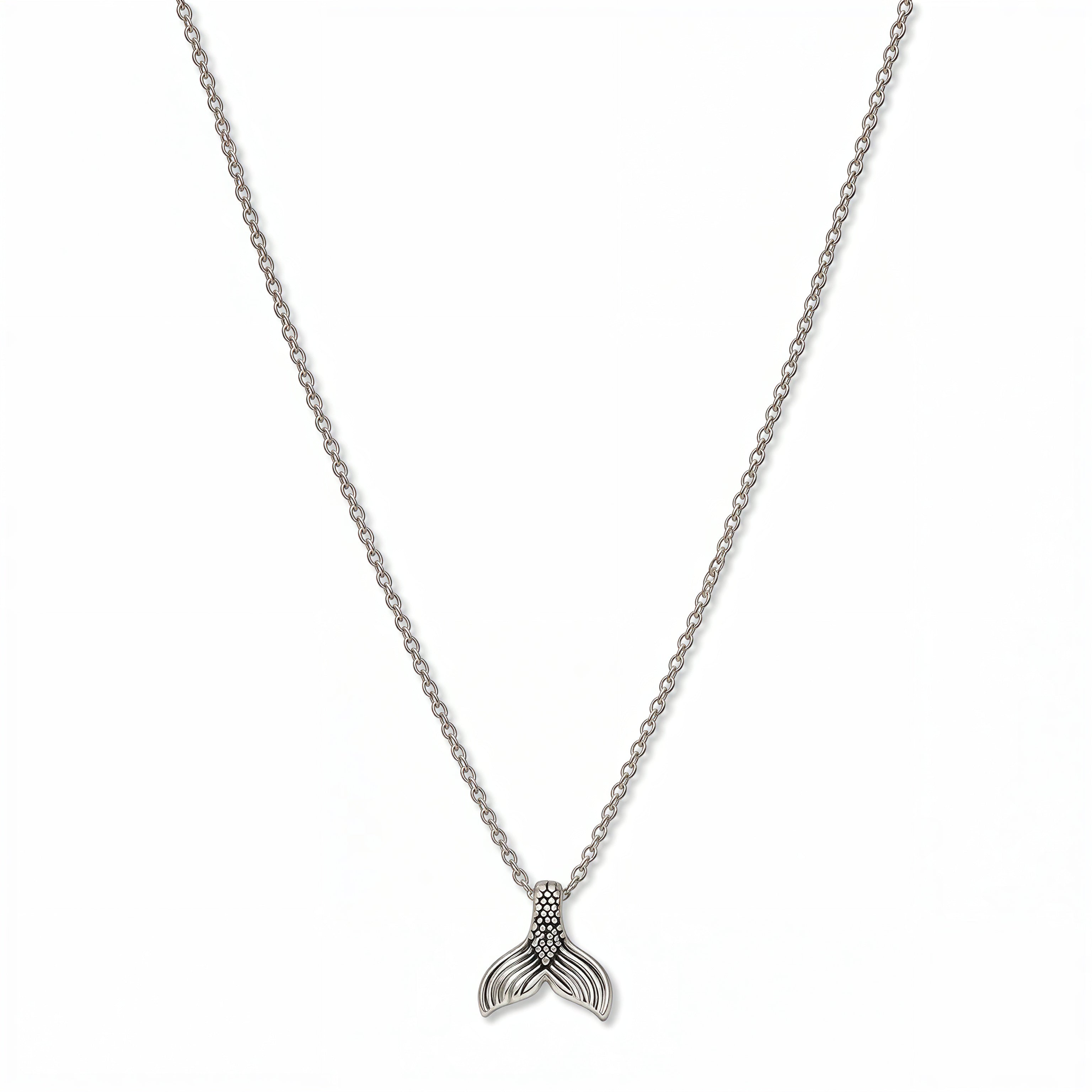A Mermaid Tail Pendant Necklace by Skōsh Jewelry, featuring a small textured mermaid tail pendant on a fine sterling silver chain, displayed against a white background.