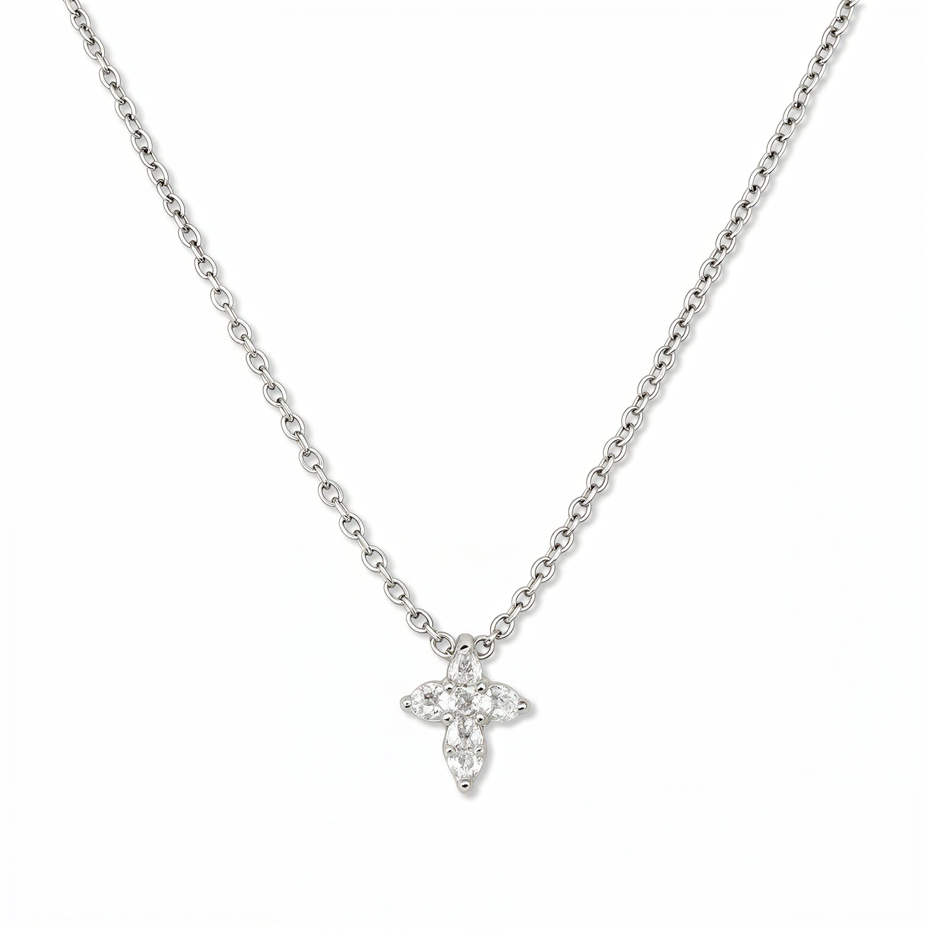A Faithful Mini Cross with White Cubic Zirconia Necklace by Skōsh Jewelry, featuring a petite cross formed from small clear stones on a fine sterling silver chain, displayed against a white background.