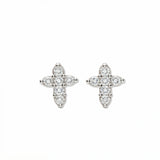 A pair of Shine Mini Cross with White Cubic Zirconia Earrings by Skōsh Jewelry, featuring small crosses formed from clear stones in sterling silver, displayed against a white background.