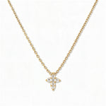 A Faithful Mini Cross with White Cubic Zirconia Necklace by Skōsh Jewelry, featuring a petite cross formed from small clear stones on a fine gold chain, displayed against a white background.