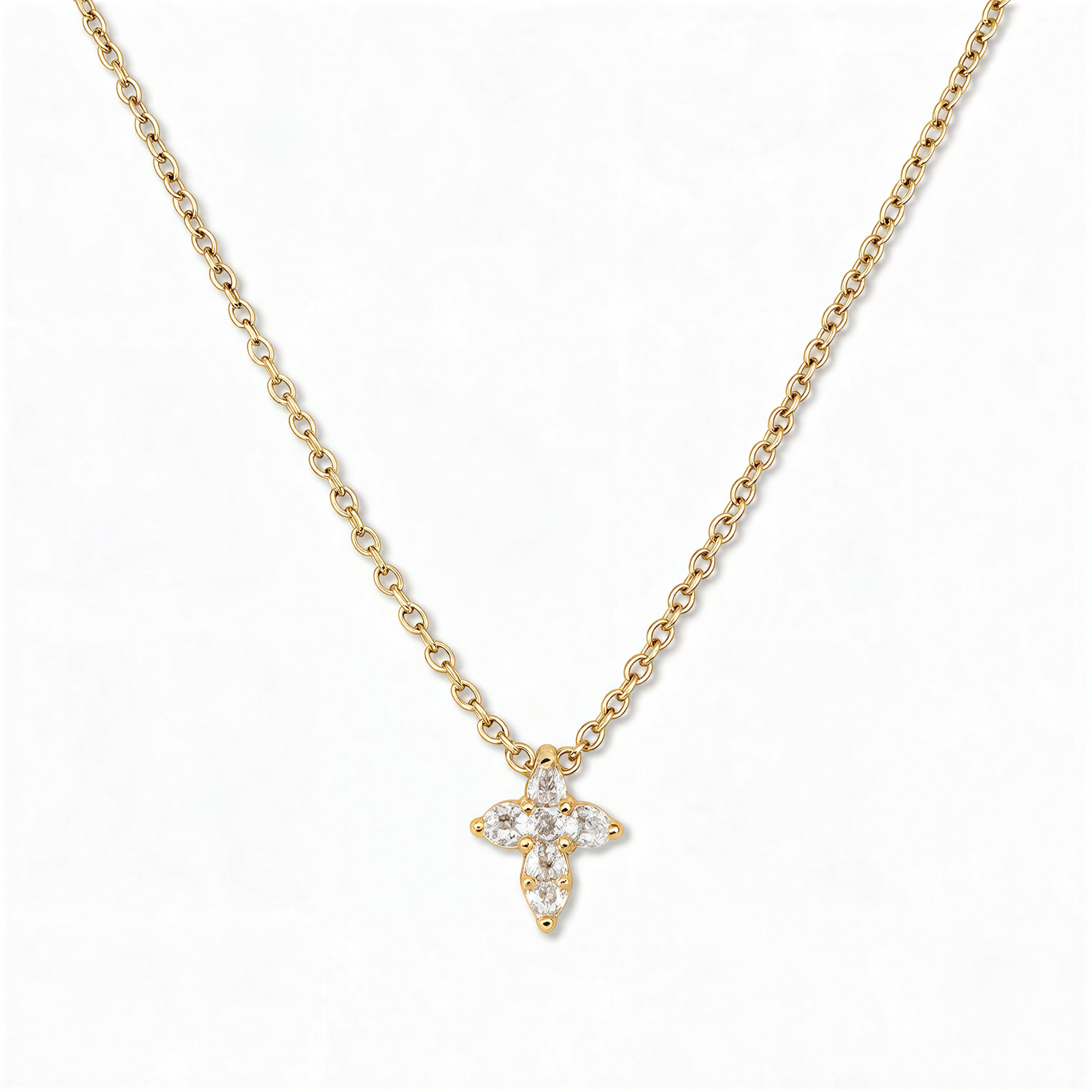 A Faithful Mini Cross with White Cubic Zirconia Necklace by Skōsh Jewelry, featuring a petite cross formed from small clear stones on a fine gold chain, displayed against a white background.