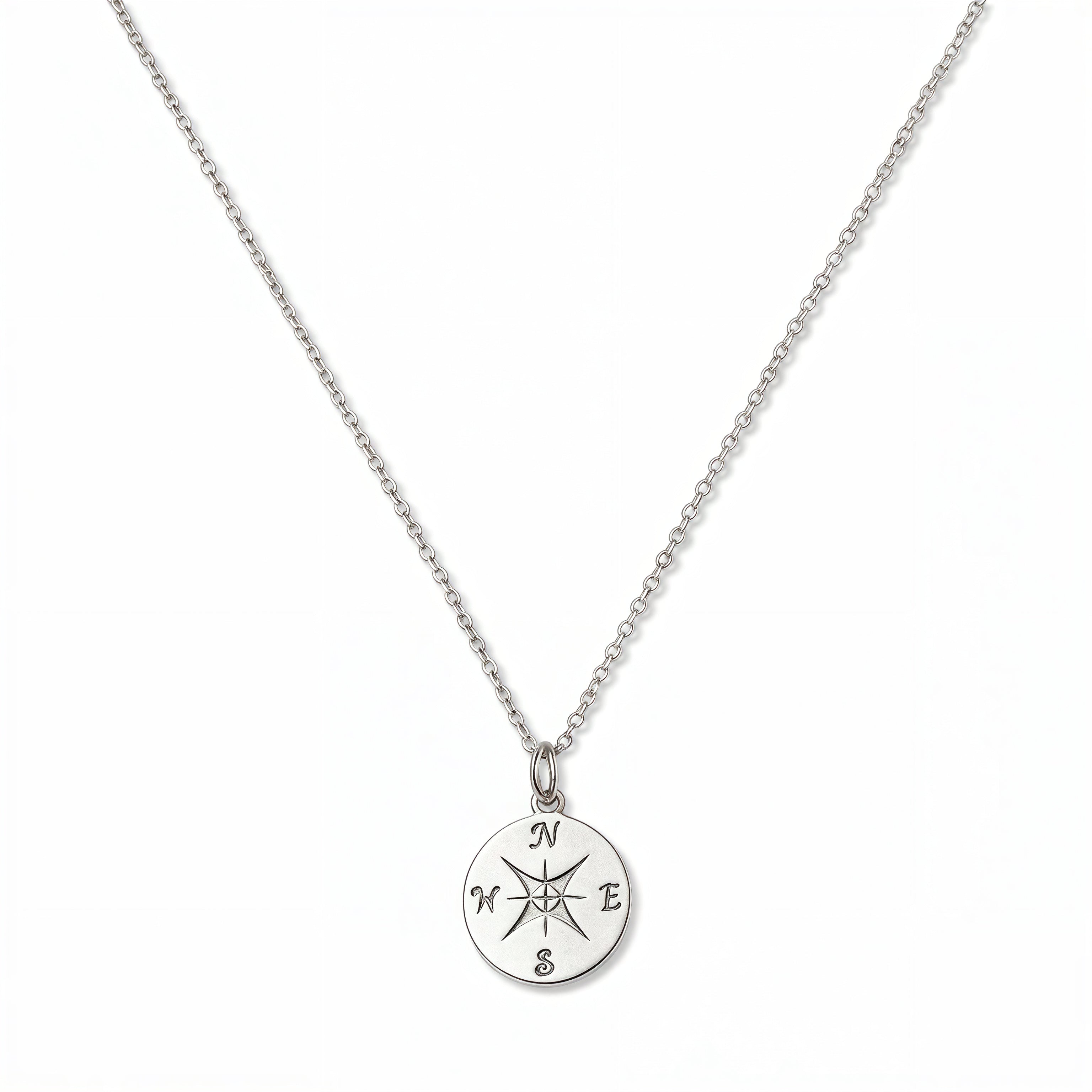 A True North Engraved Compass Pendant Necklace by Skōsh Jewelry, featuring a round compass medallion engraved with a compass rose on a fine sterling silver chain, displayed against a white background.