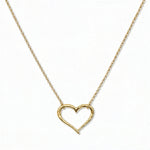 A Tender Heart Necklace by Skōsh Jewelry, featuring a large open heart outline set on a fine gold chain, displayed against a white background.