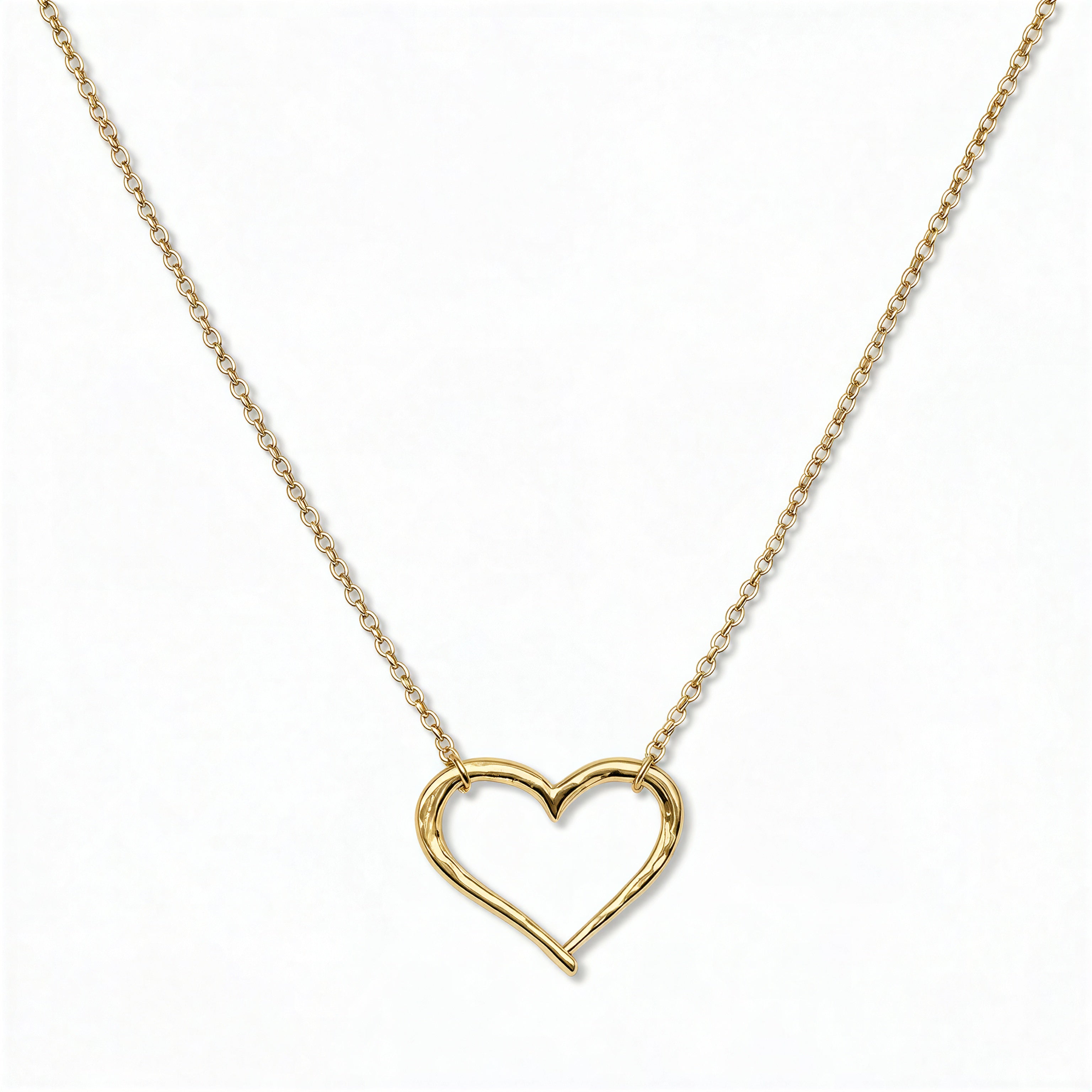 A Tender Heart Necklace by Skōsh Jewelry, featuring a large open heart outline set on a fine gold chain, displayed against a white background.